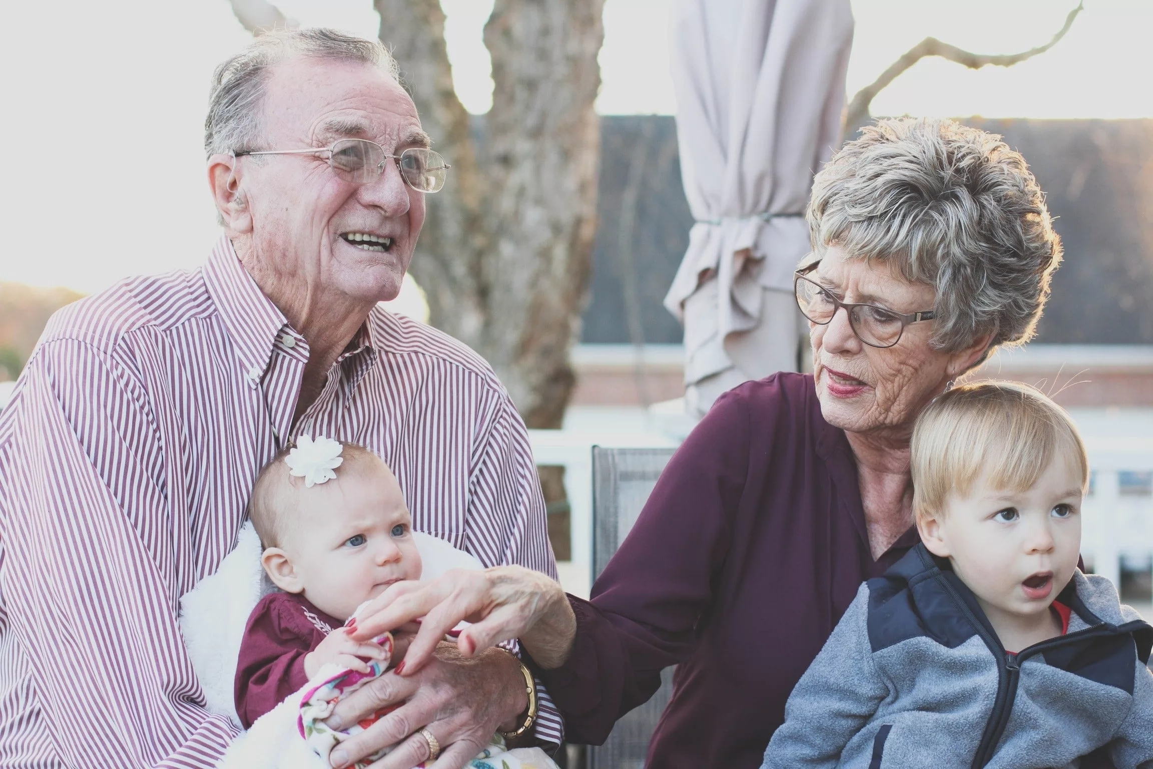 long distance grandparents holding two young grandchildren